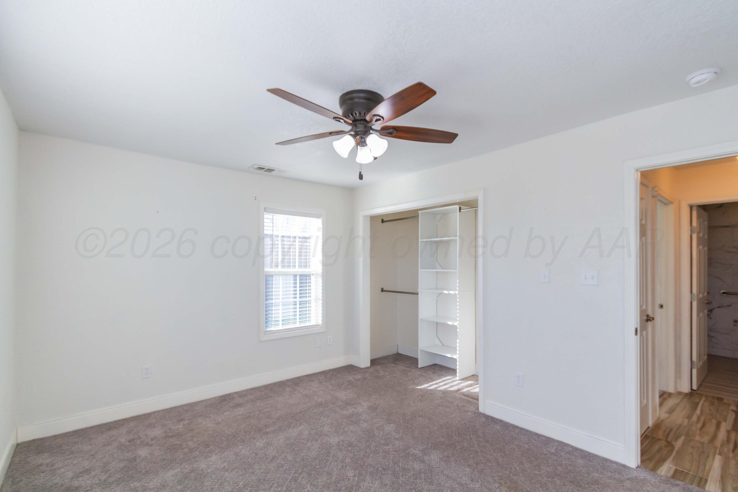 706 Pittsburg Street Amarillo, TX 79104 - Photo 14 of 22 a view of a livingroom with a ceiling fan and window