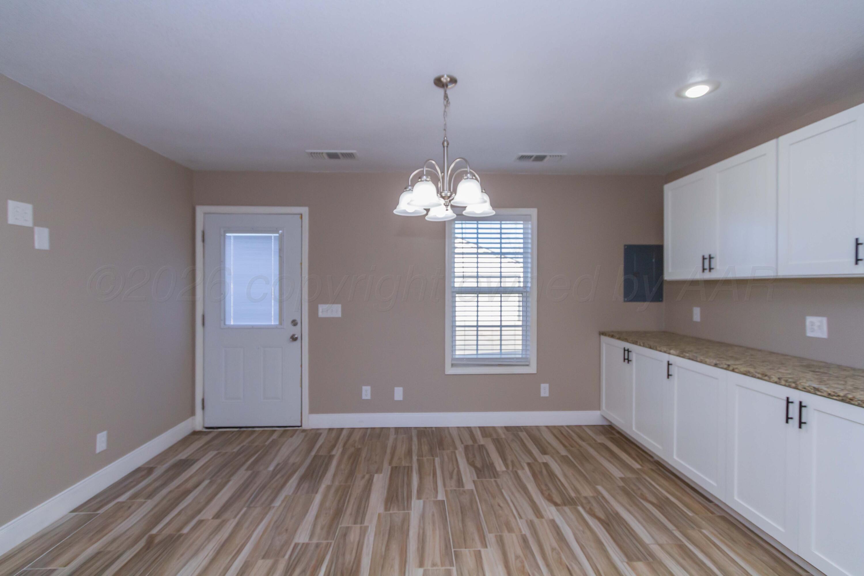 706 Pittsburg Street Amarillo, TX 79104 - Photo 9 of 22 a view of an empty room with window and cabinet