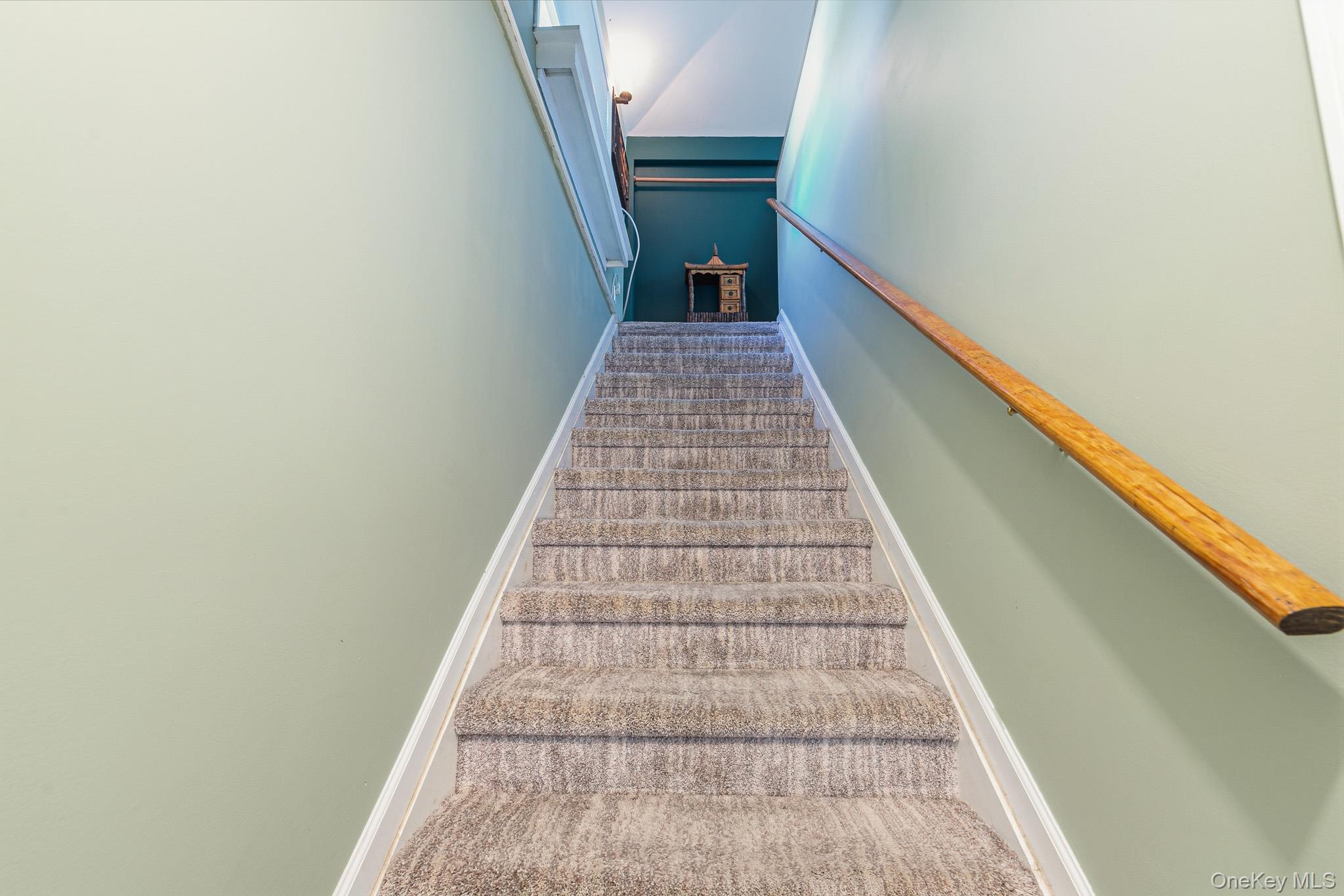 33 Lillian Road Nesconset, NY 11767 - Photo 23 of 42 A Lovely Stairway Off Of The Kitchen Leads To The Stunning Primary Bedroom Suite.