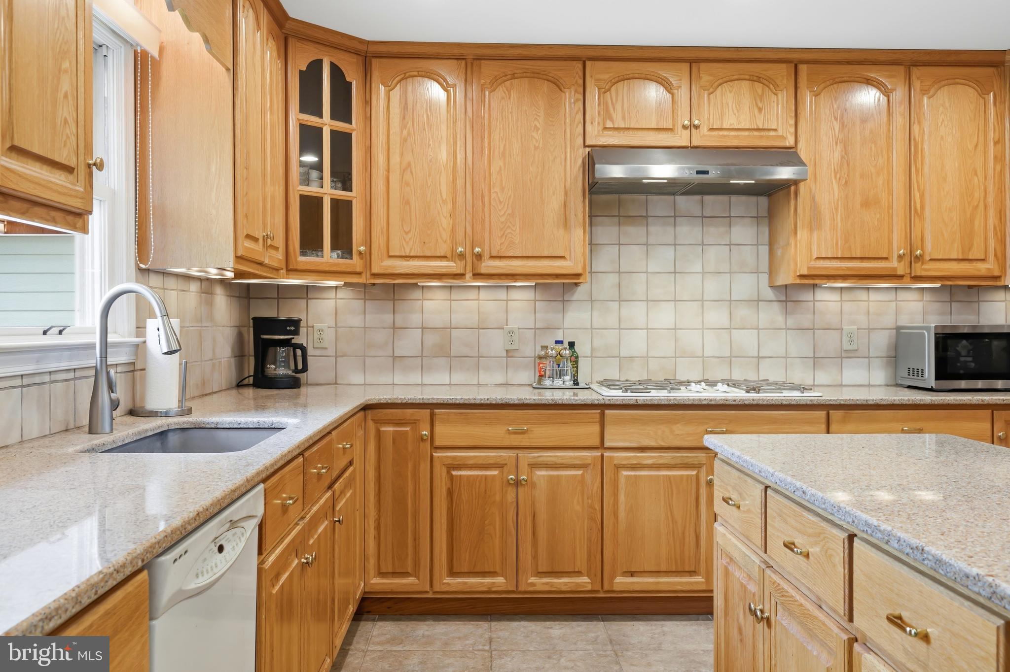 25714 Edgeview Road Royal Oak, MD 21662 - Photo 12 of 39 a kitchen with granite countertop a sink and cabinets