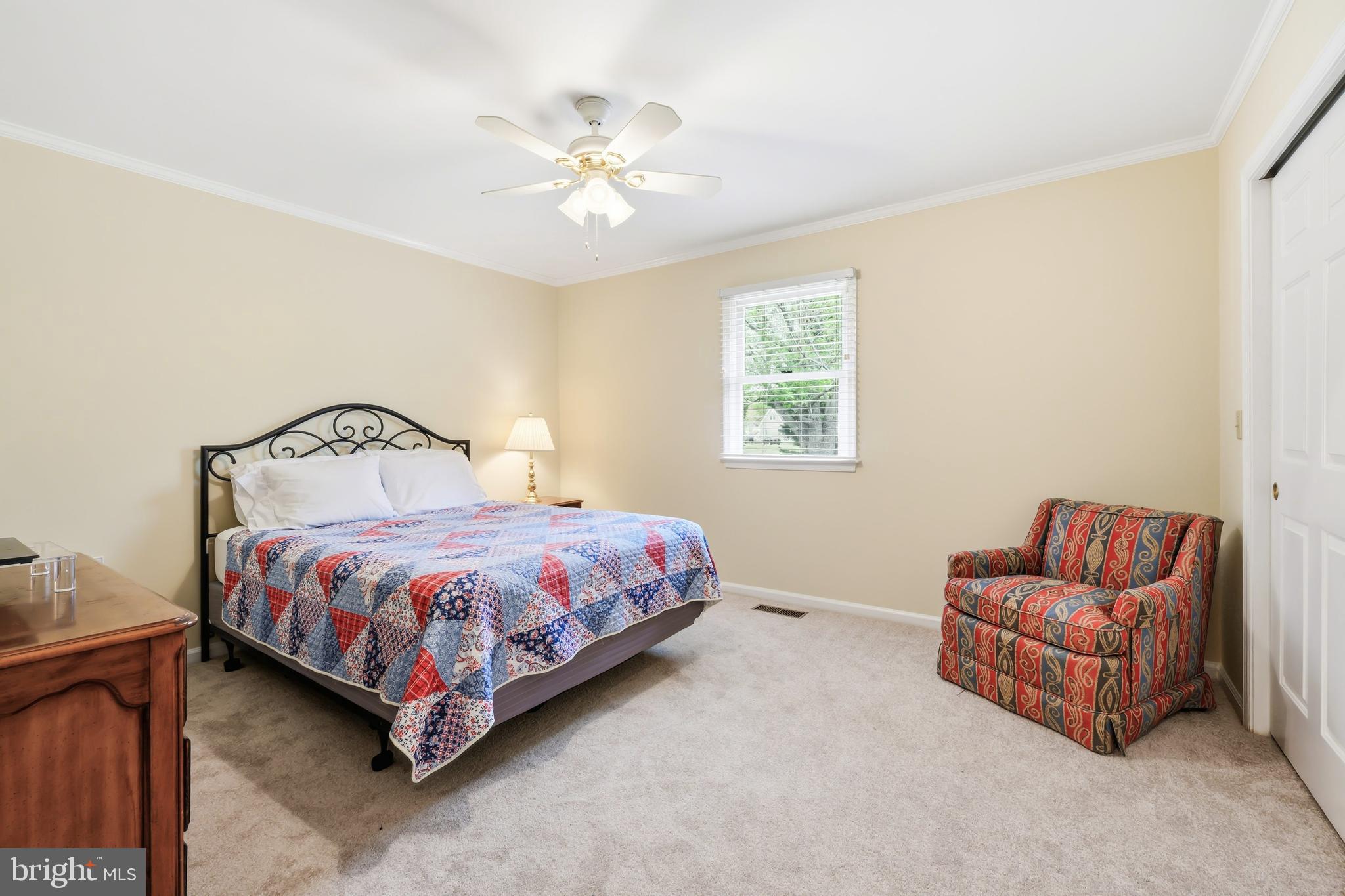 25714 Edgeview Road Royal Oak, MD 21662 - Photo 16 of 39 a bedroom with a bed and ceiling fan