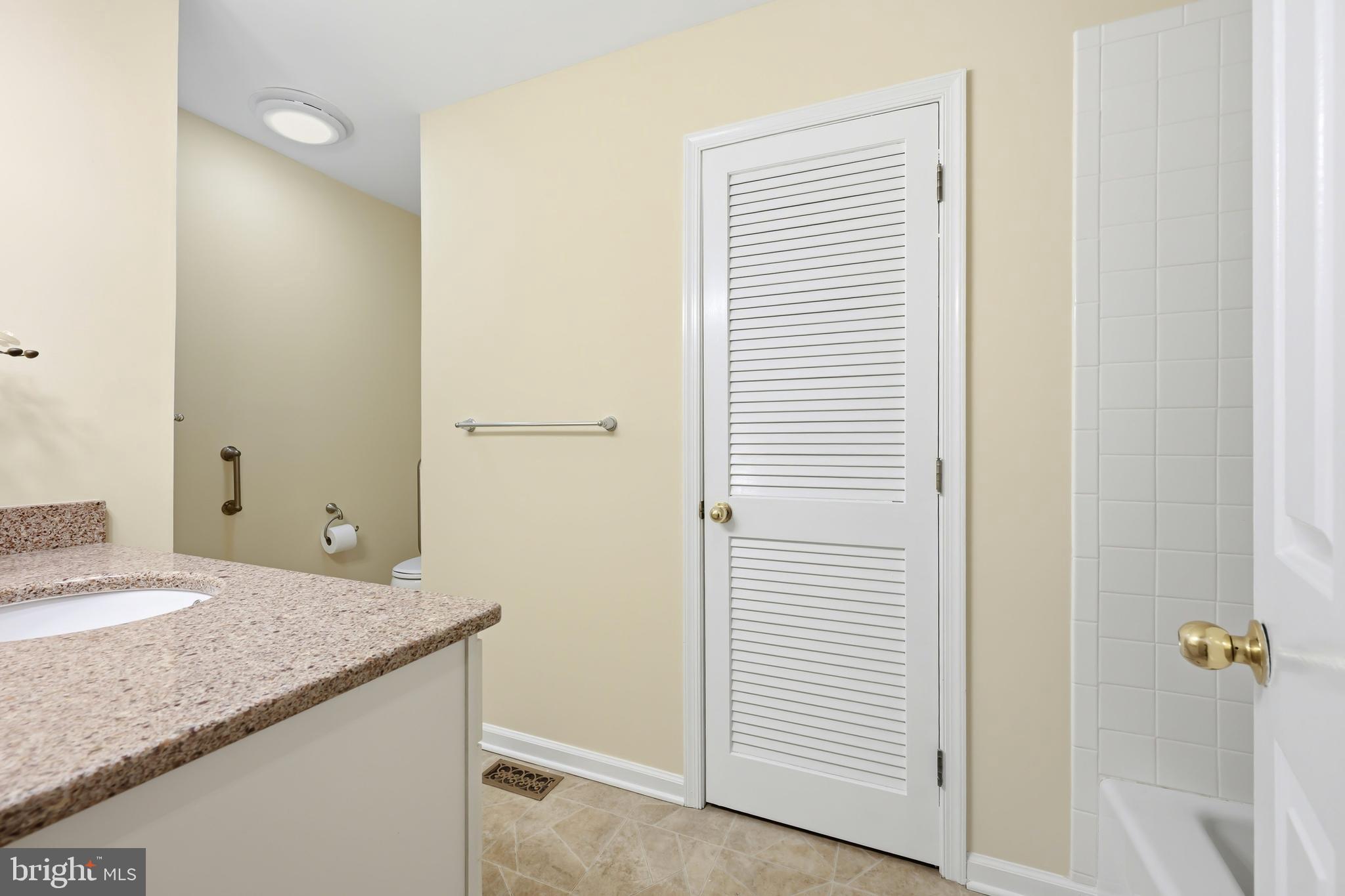 25714 Edgeview Road Royal Oak, MD 21662 - Photo 18 of 39 a bathroom with a granite countertop sink and a mirror