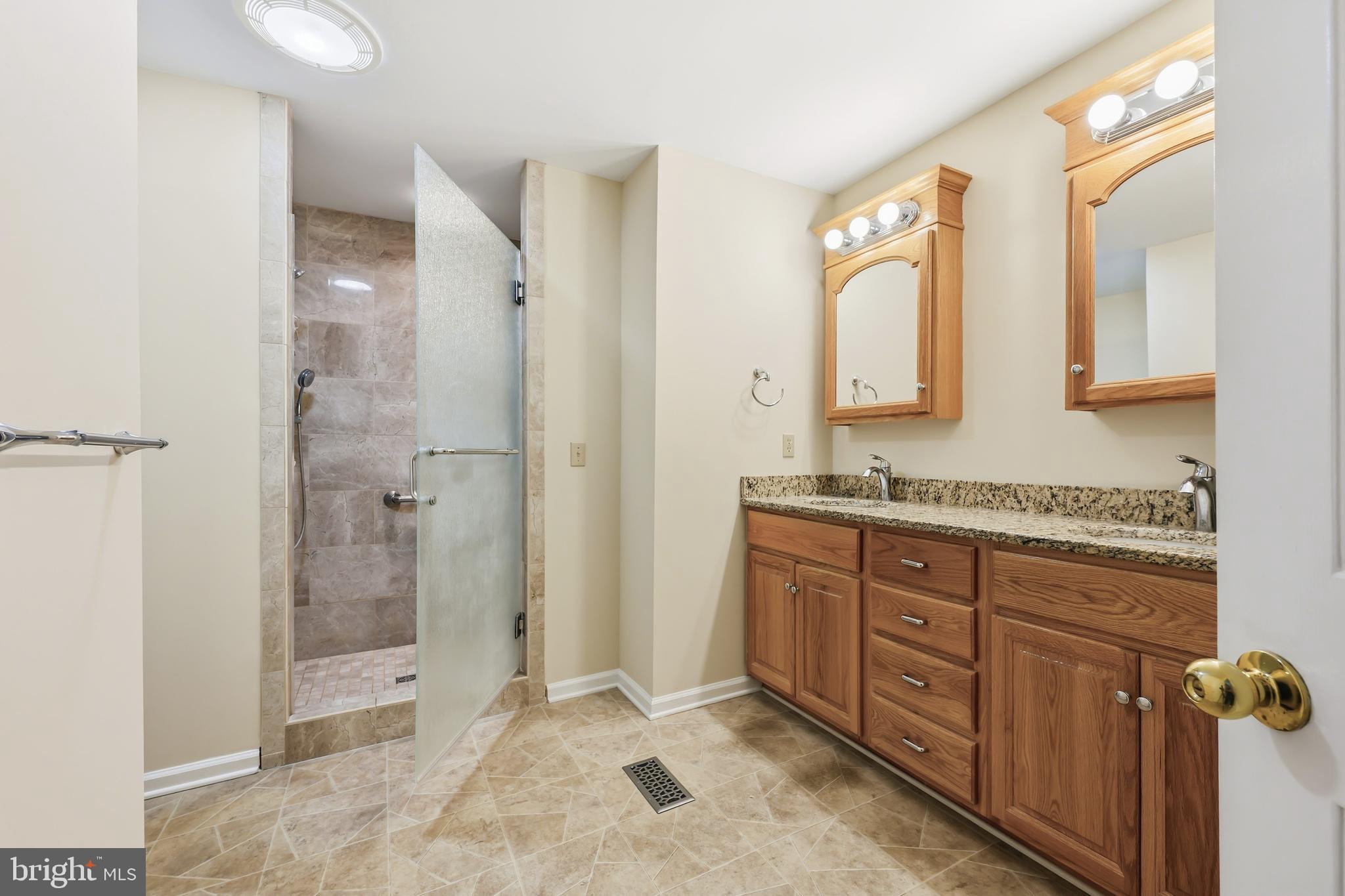 25714 Edgeview Road Royal Oak, MD 21662 - Photo 22 of 39 a bathroom with a granite countertop sink mirror and shower