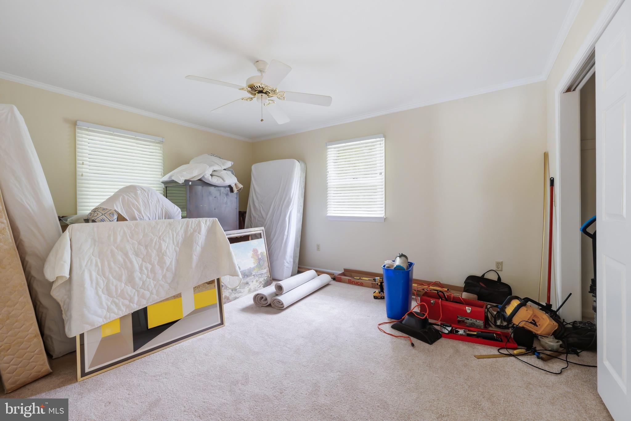 25714 Edgeview Road Royal Oak, MD 21662 - Photo 24 of 39 a bedroom with bed and a chandelier