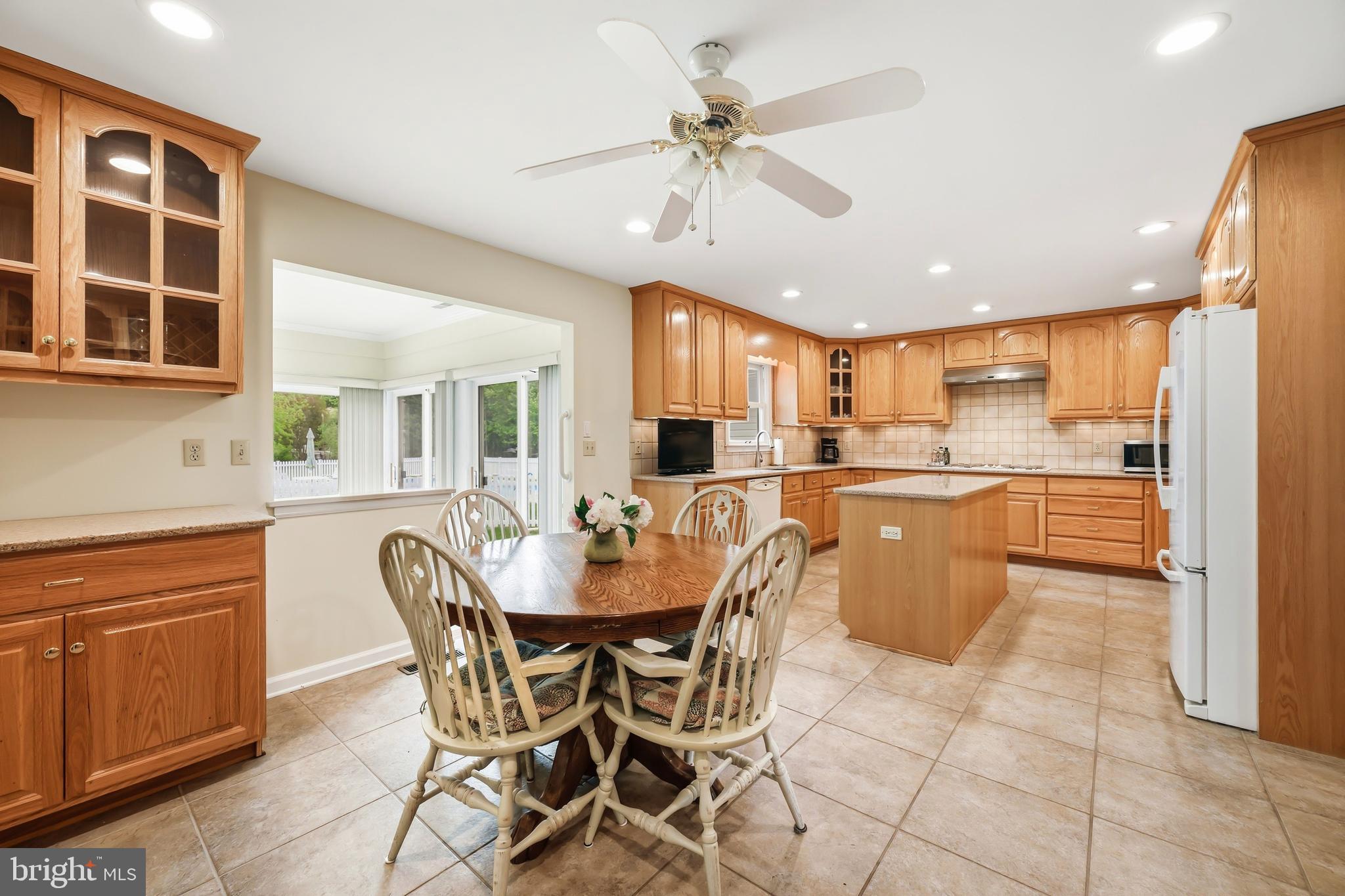 25714 Edgeview Road Royal Oak, MD 21662 - Photo 10 of 39 a dining room with stainless steel appliances kitchen island granite countertop a dining table chairs and granite counter tops