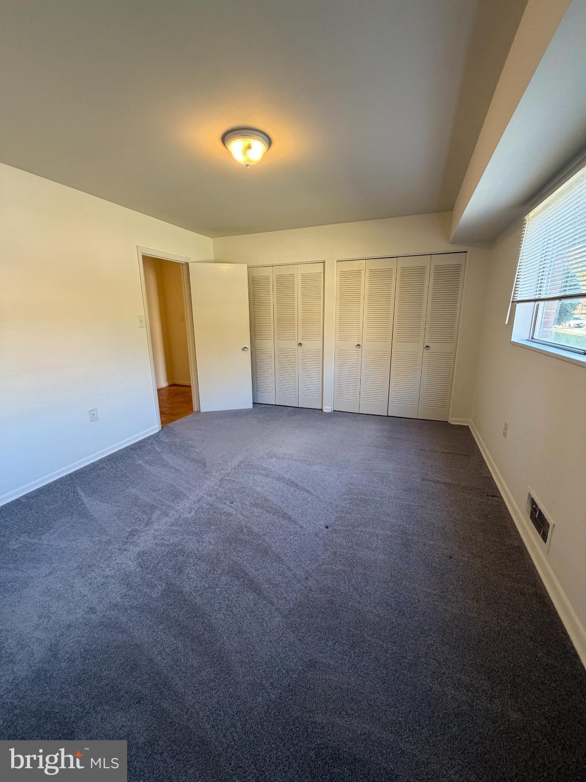 10661 Weymouth Street, Unit 101 Bethesda, MD 20814 - Photo 14 of 23 an empty room with a empty space and windows