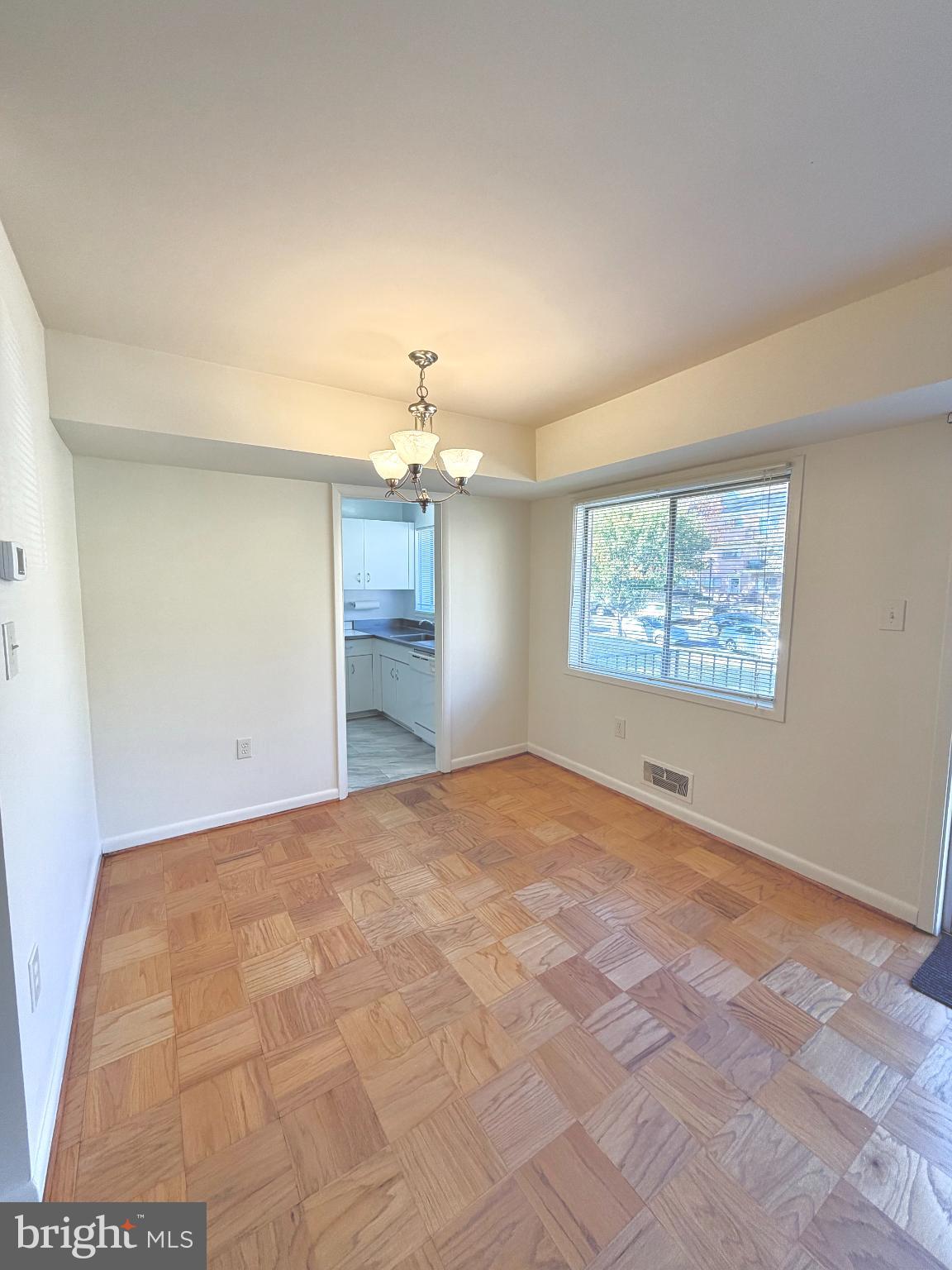 10661 Weymouth Street, Unit 101 Bethesda, MD 20814 - Photo 9 of 23 a view of an empty room with a window