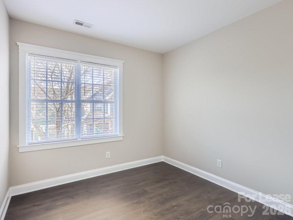 249 Faust Road Davidson, NC 28036 - Photo 11 of 21 an empty room with wooden floor and windows
