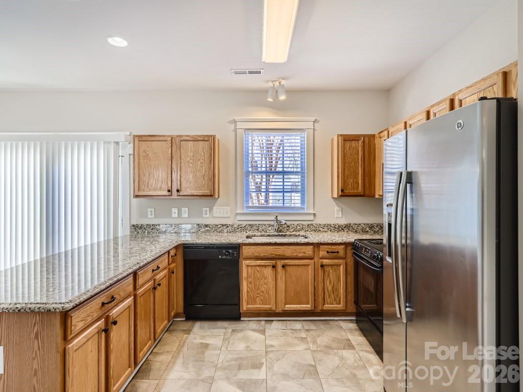 249 Faust Road Davidson, NC 28036 - Photo 4 of 21 a kitchen with stainless steel appliances granite countertop a sink stove and refrigerator