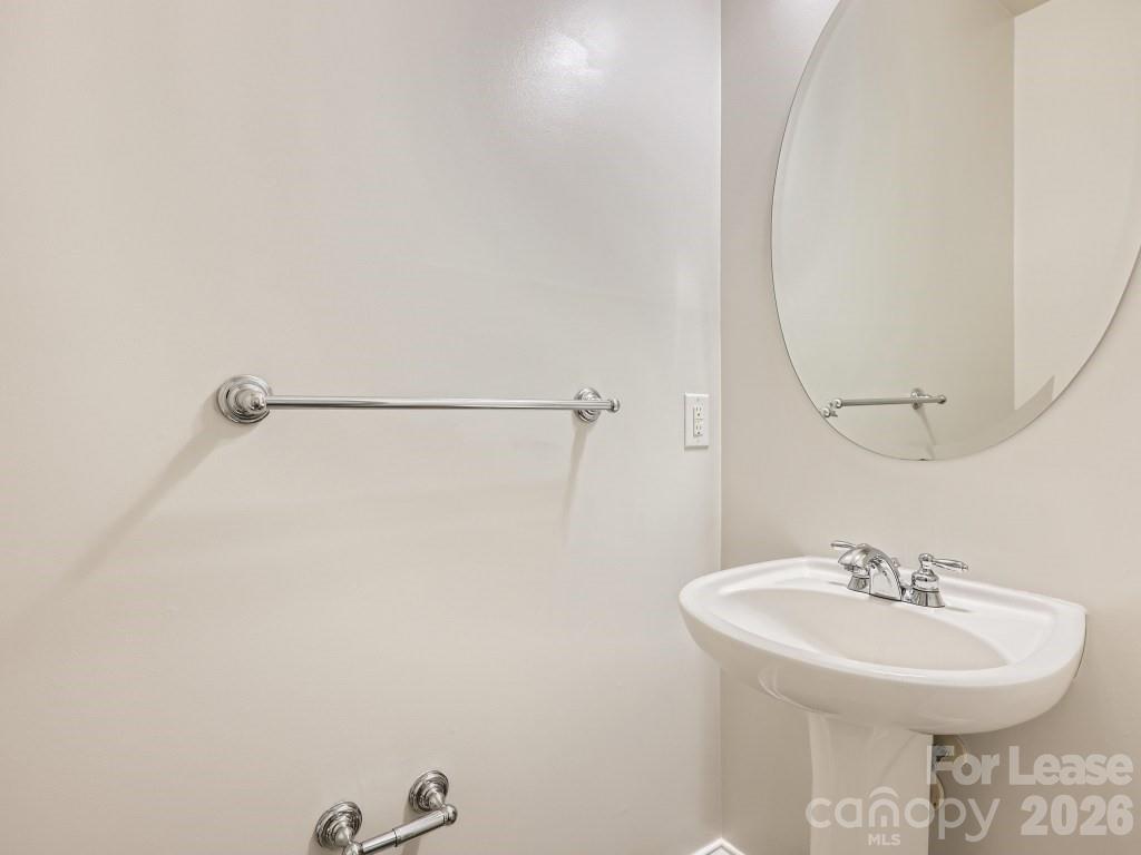 249 Faust Road Davidson, NC 28036 - Photo 6 of 21 a bathroom with a sink a mirror and a shower