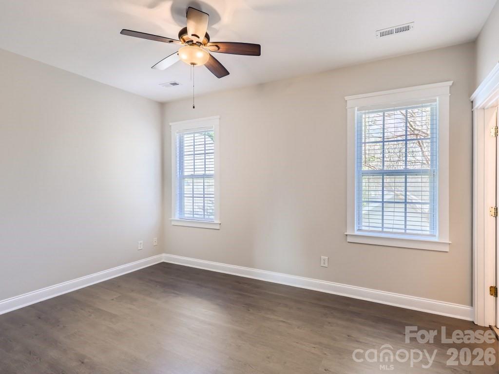 249 Faust Road Davidson, NC 28036 - Photo 7 of 21 an empty room with chandelier fan and windows