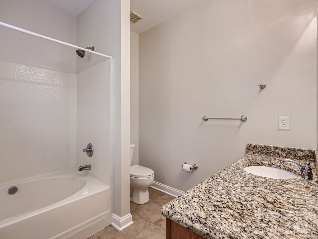 249 Faust Road Davidson, NC 28036 - Photo 9 of 21 a bathroom with a sink a toilet and a bathtub