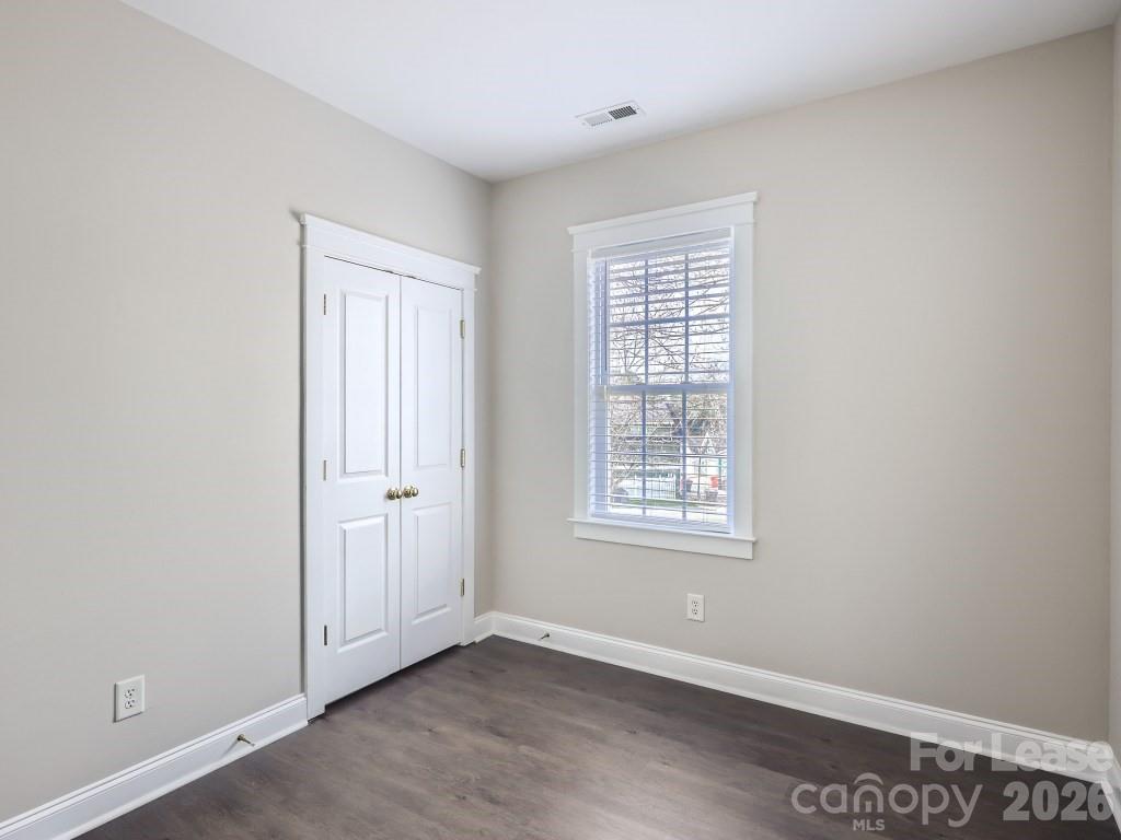 249 Faust Road Davidson, NC 28036 - Photo 10 of 21 a view of an empty room with wooden floor and a window