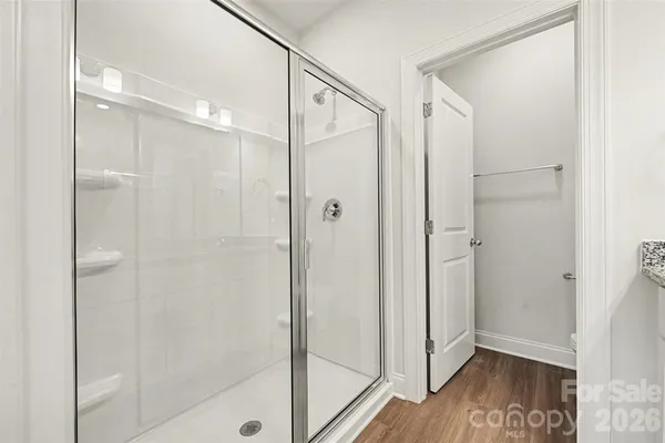 a bathroom with a glass shower door