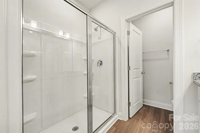a bathroom with a glass shower door