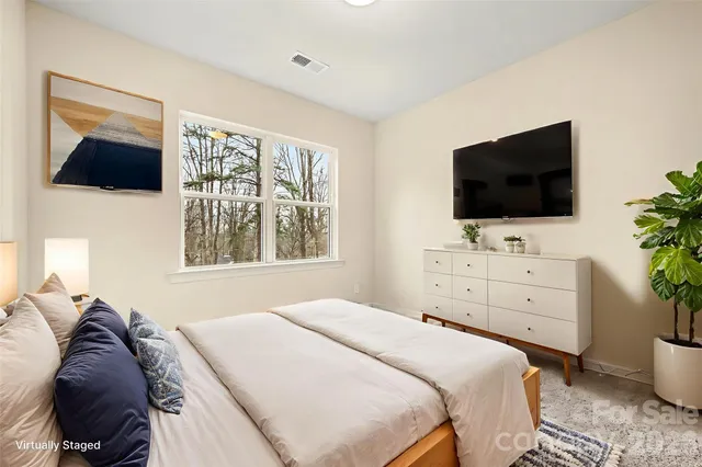a bedroom with a bed and a flat screen tv