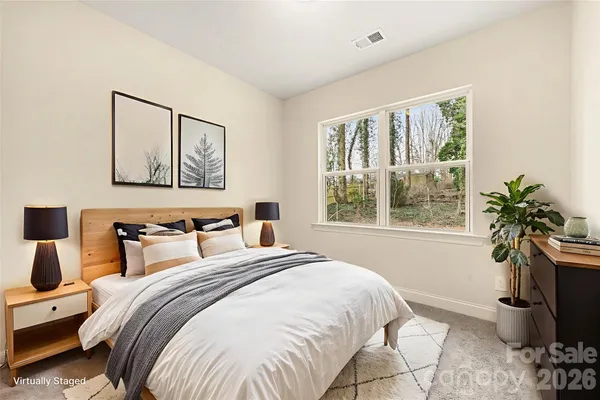 a bedroom with a bed and a large window