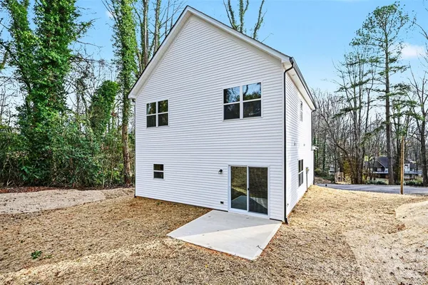a view of a white house with a yard covered in snow