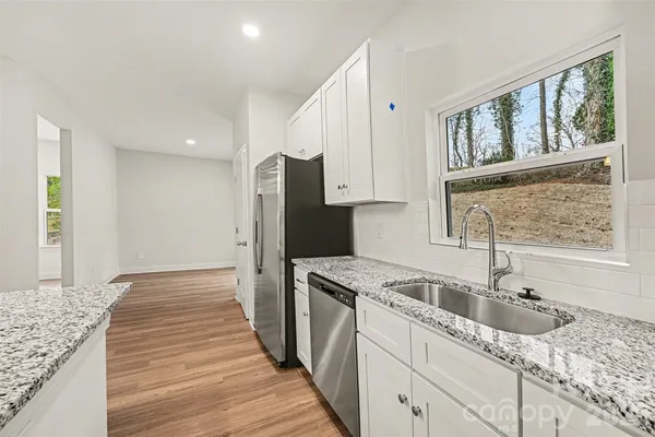 a kitchen with a sink stove and refrigerator