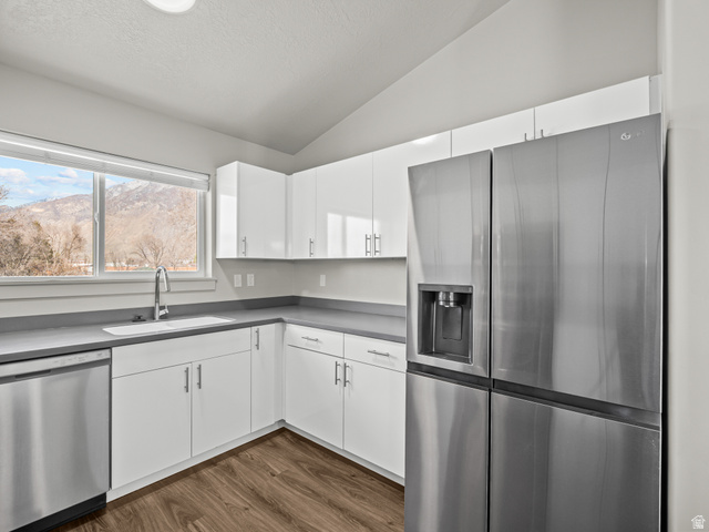 64 West 600 South, Unit C301 Springville, UT 84663 - Photo 15 of 40 Kitchen featuring stainless steel appliances, white cabinetry, lofted ceiling, dark wood-style flooring, and a mountain view