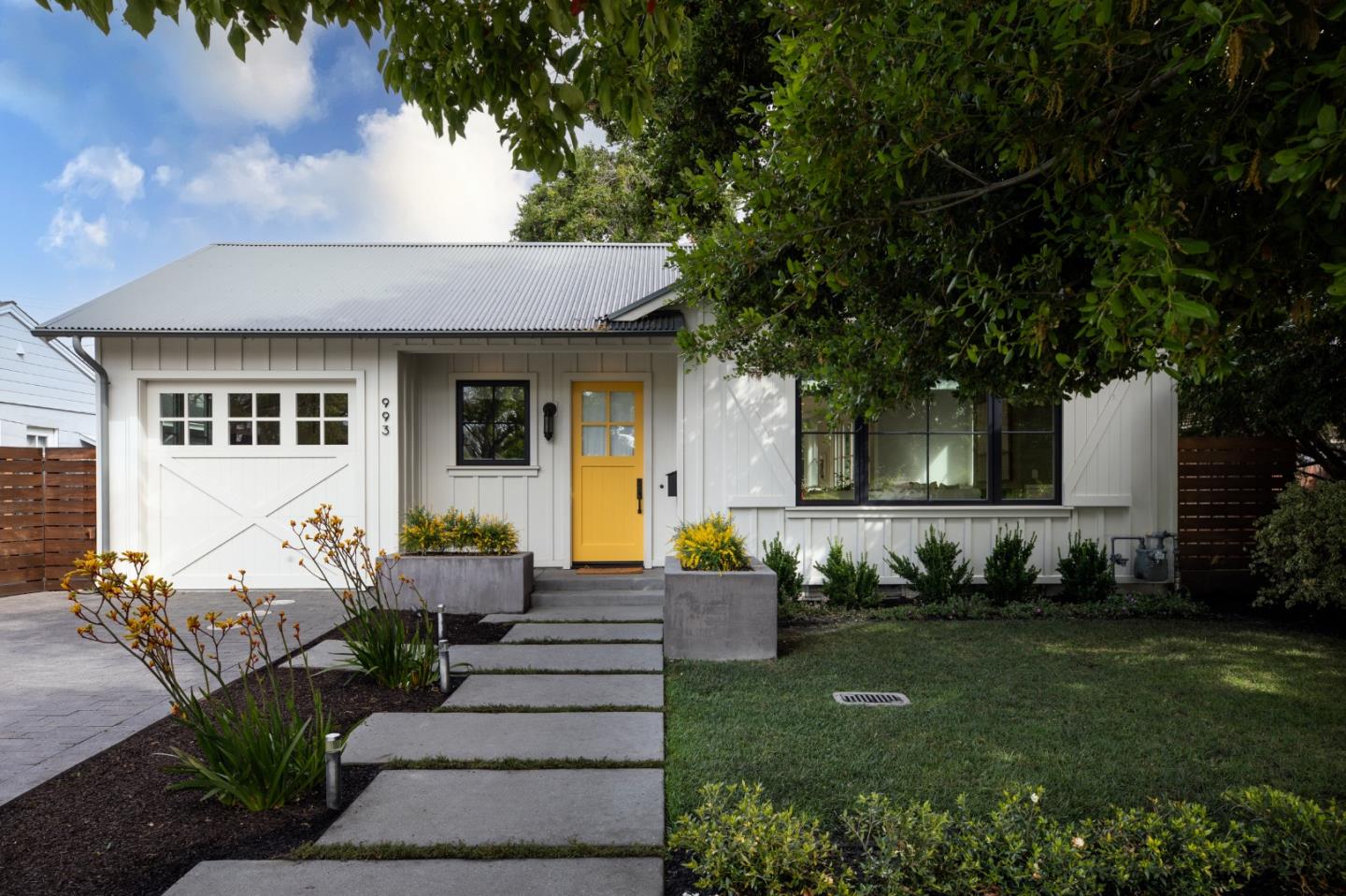 993 Embarcadero Road Palo Alto, CA 94303 - Photo 1 of 24 a front view of a house with a garden