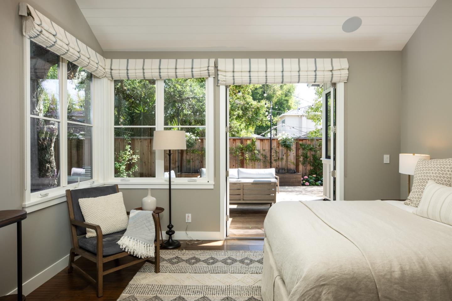 993 Embarcadero Road Palo Alto, CA 94303 - Photo 12 of 24 a bedroom with a large window and a chair