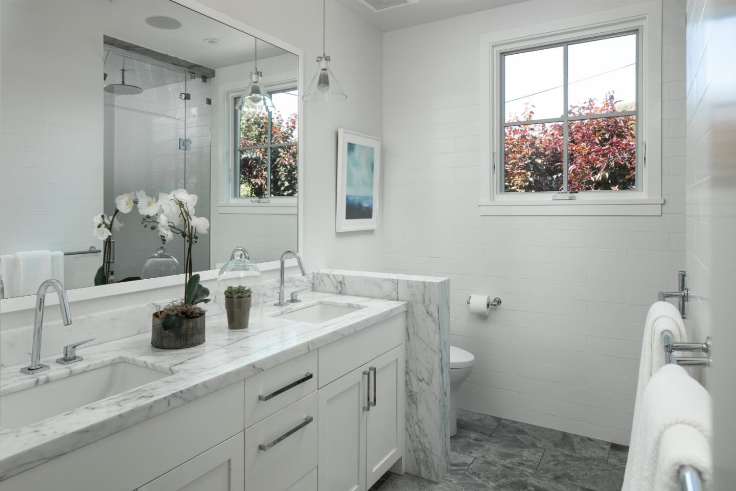 993 Embarcadero Road Palo Alto, CA 94303 - Photo 14 of 24 a bathroom with a double vanity sink toilet and a mirror