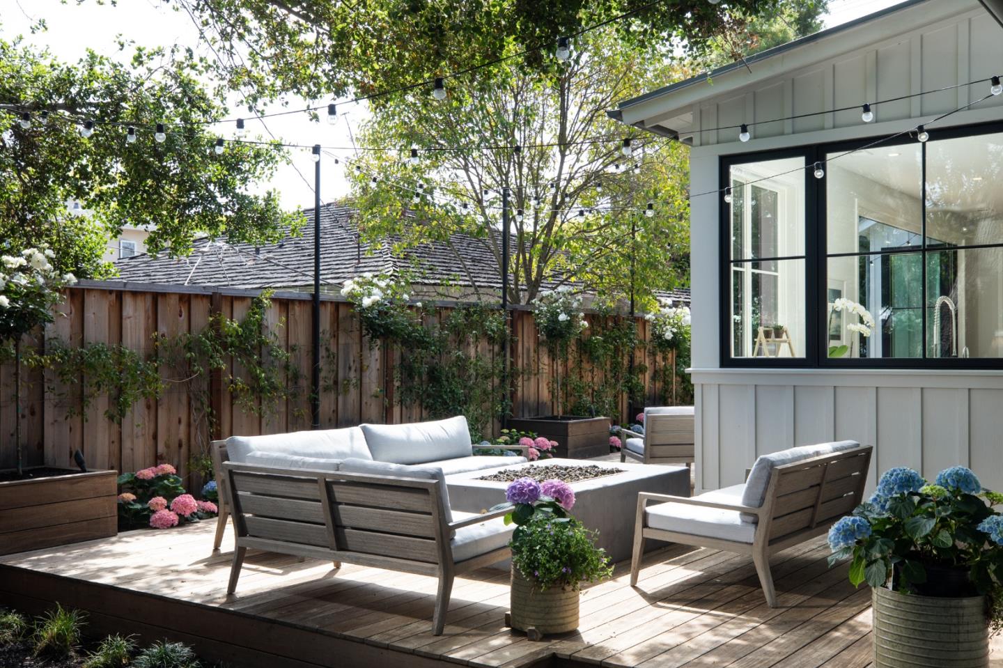 993 Embarcadero Road Palo Alto, CA 94303 - Photo 21 of 24 a view of a patio with table and chairs potted plants and a palm tree