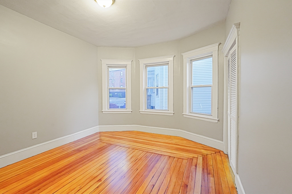 381 Adams Street, Unit 1 Boston, MA 02122 - Photo 12 of 42 a view of a room with wooden floor and natural light