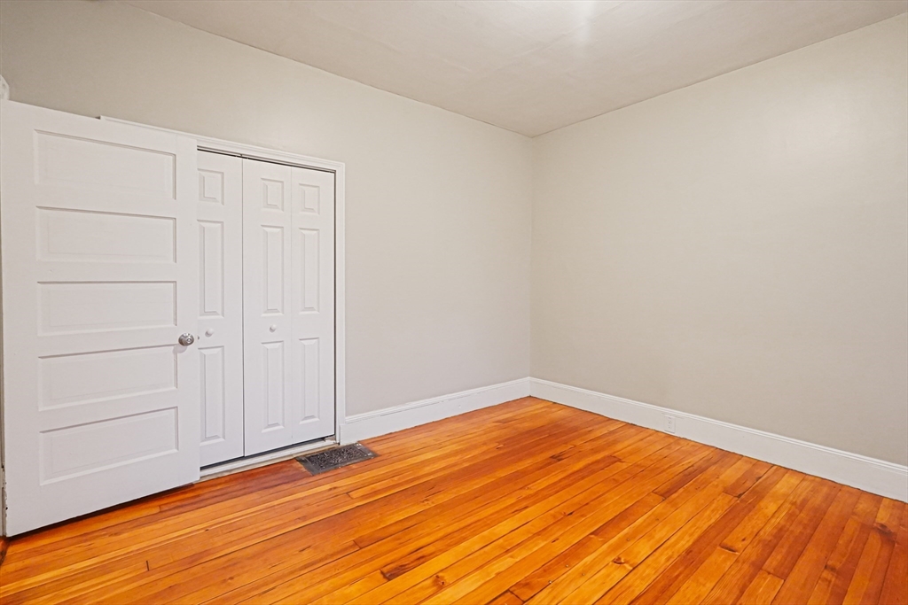 381 Adams Street, Unit 1 Boston, MA 02122 - Photo 17 of 42 a view of empty room with wooden floor