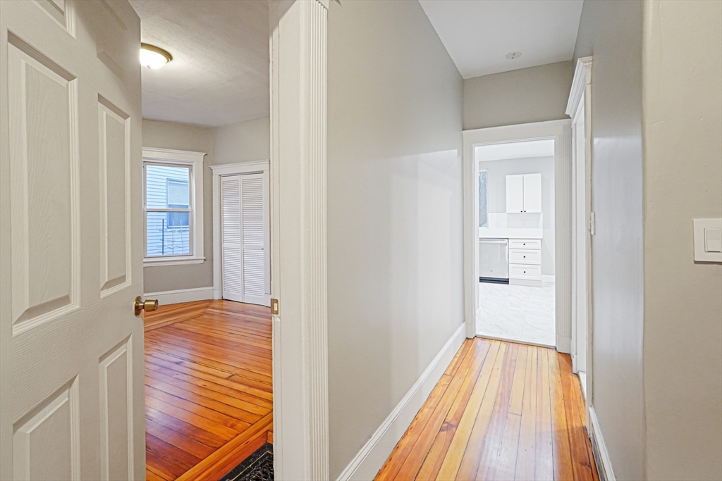 381 Adams Street, Unit 1 Boston, MA 02122 - Photo 19 of 42 a view of hallway with wooden floor