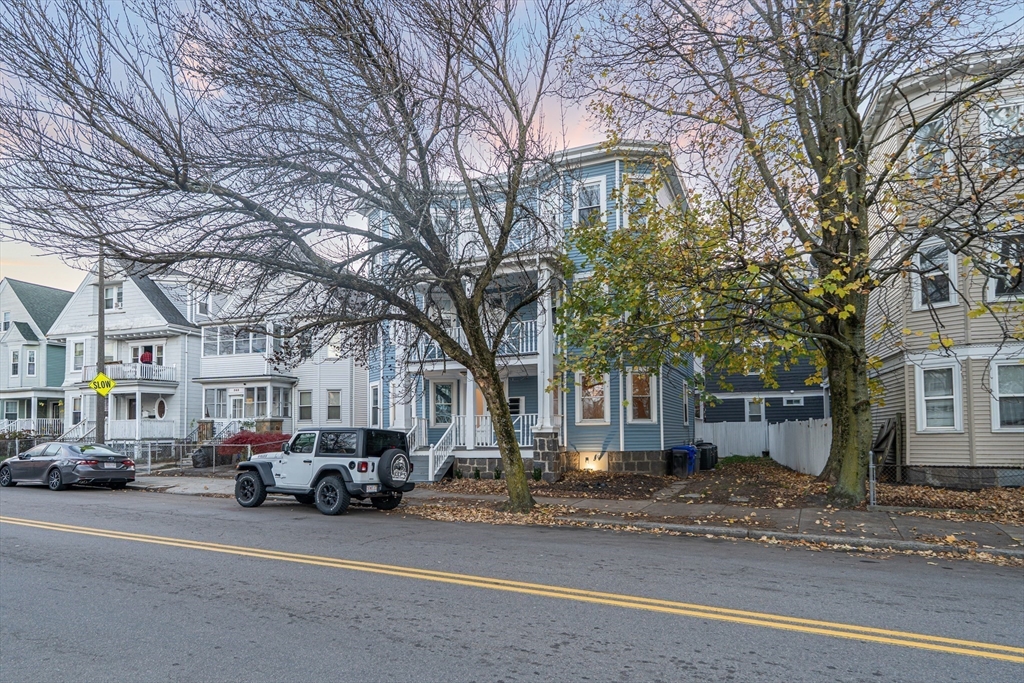 381 Adams Street, Unit 1 Boston, MA 02122 - Photo 32 of 42 a city street lined with buildings and cars