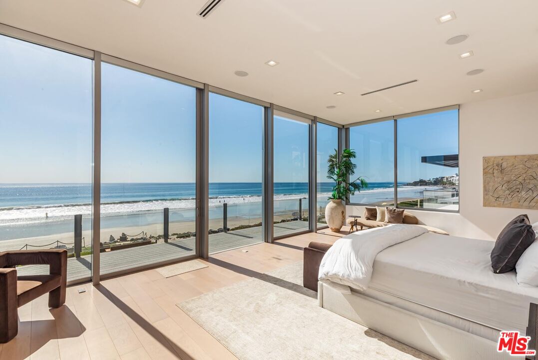 31220 Broad Beach Road Malibu, CA 90265 - Photo 12 of 33 a bedroom with a bed and large window with balcony view