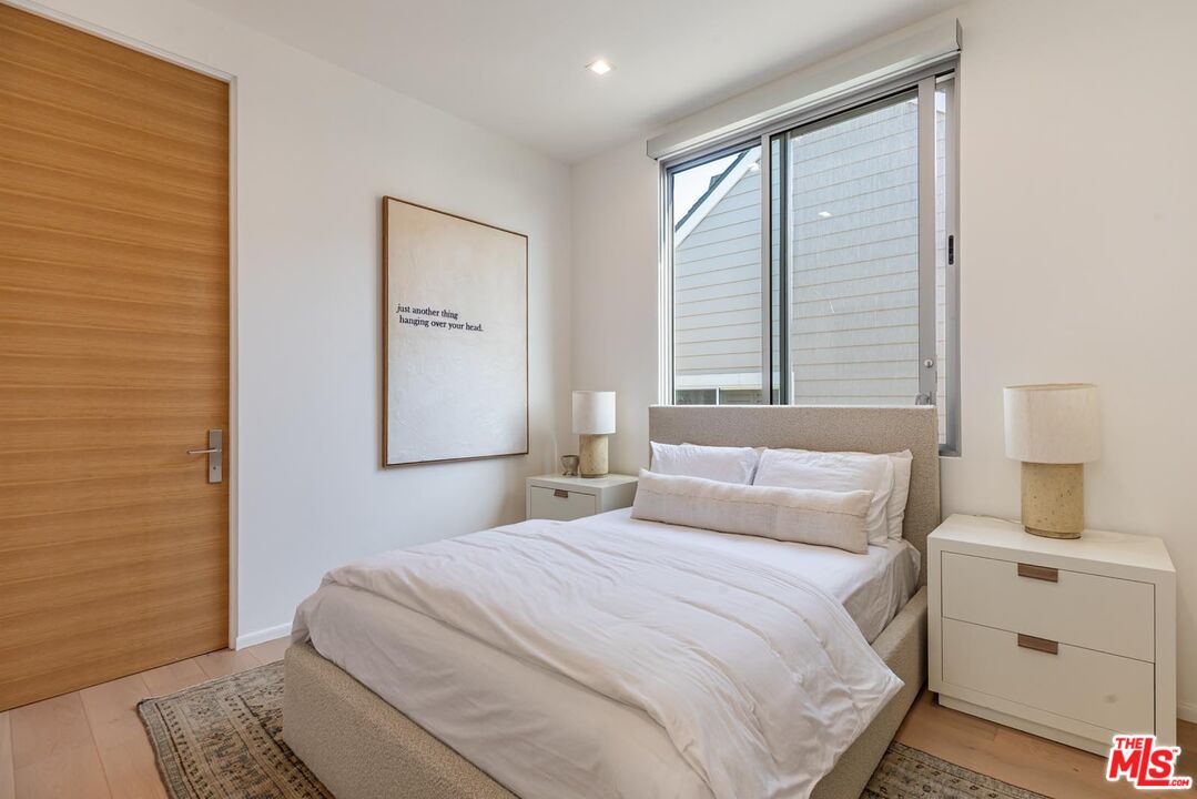31220 Broad Beach Road Malibu, CA 90265 - Photo 21 of 33 a bedroom with a bed and a window