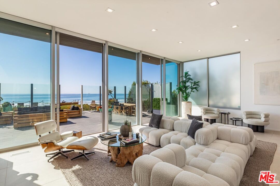 31220 Broad Beach Road Malibu, CA 90265 - Photo 5 of 33 a living room with furniture kitchen view and large windows