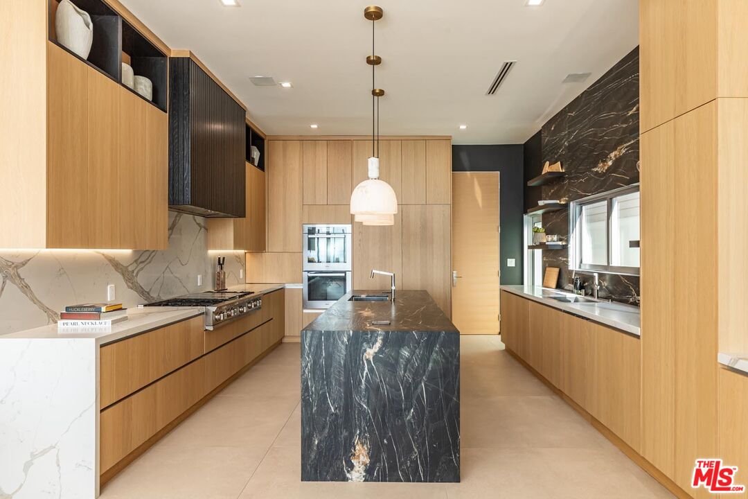 31220 Broad Beach Road Malibu, CA 90265 - Photo 7 of 33 a kitchen with stainless steel appliances granite countertop a sink stove and refrigerator