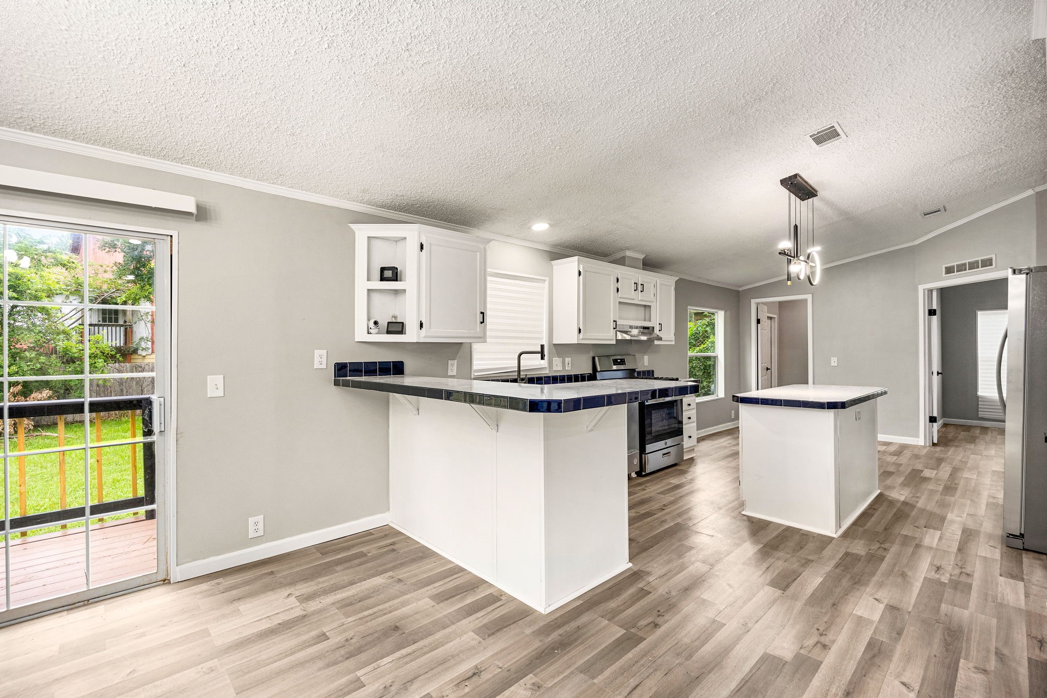14262 Shadow Bay Drive Willis, TX 77318 - Photo 5 of 26 a kitchen with a refrigerator and a stove top oven