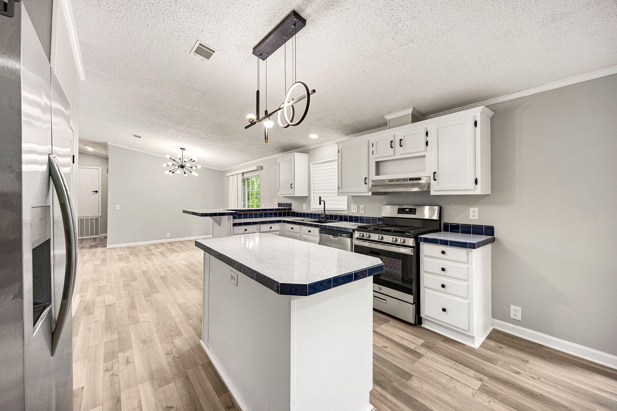14262 Shadow Bay Drive Willis, TX 77318 - Photo 6 of 26 a kitchen with stainless steel appliances granite countertop a sink stove and refrigerator