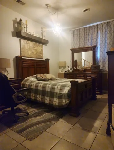 a bedroom with a bed and dresser