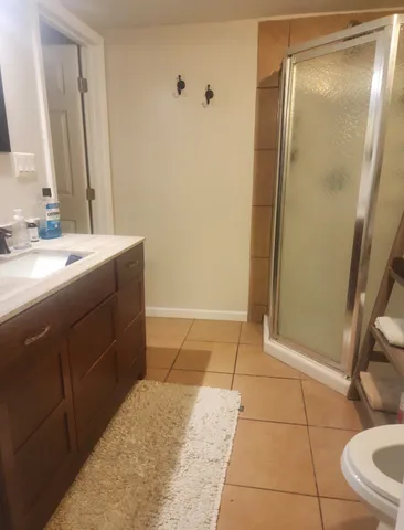 a bathroom with a toilet a sink and a mirror