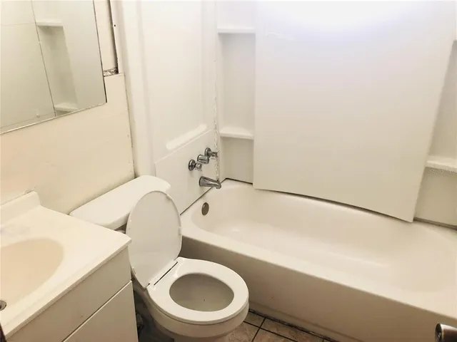 a white toilet sitting next to a bathroom sink