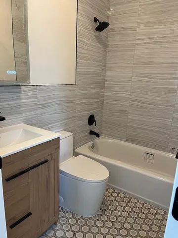 a bathroom with a sink a toilet and bathtub