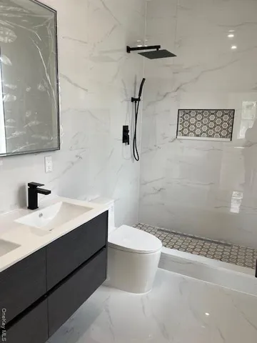 a bathroom with a sink a mirror and shower