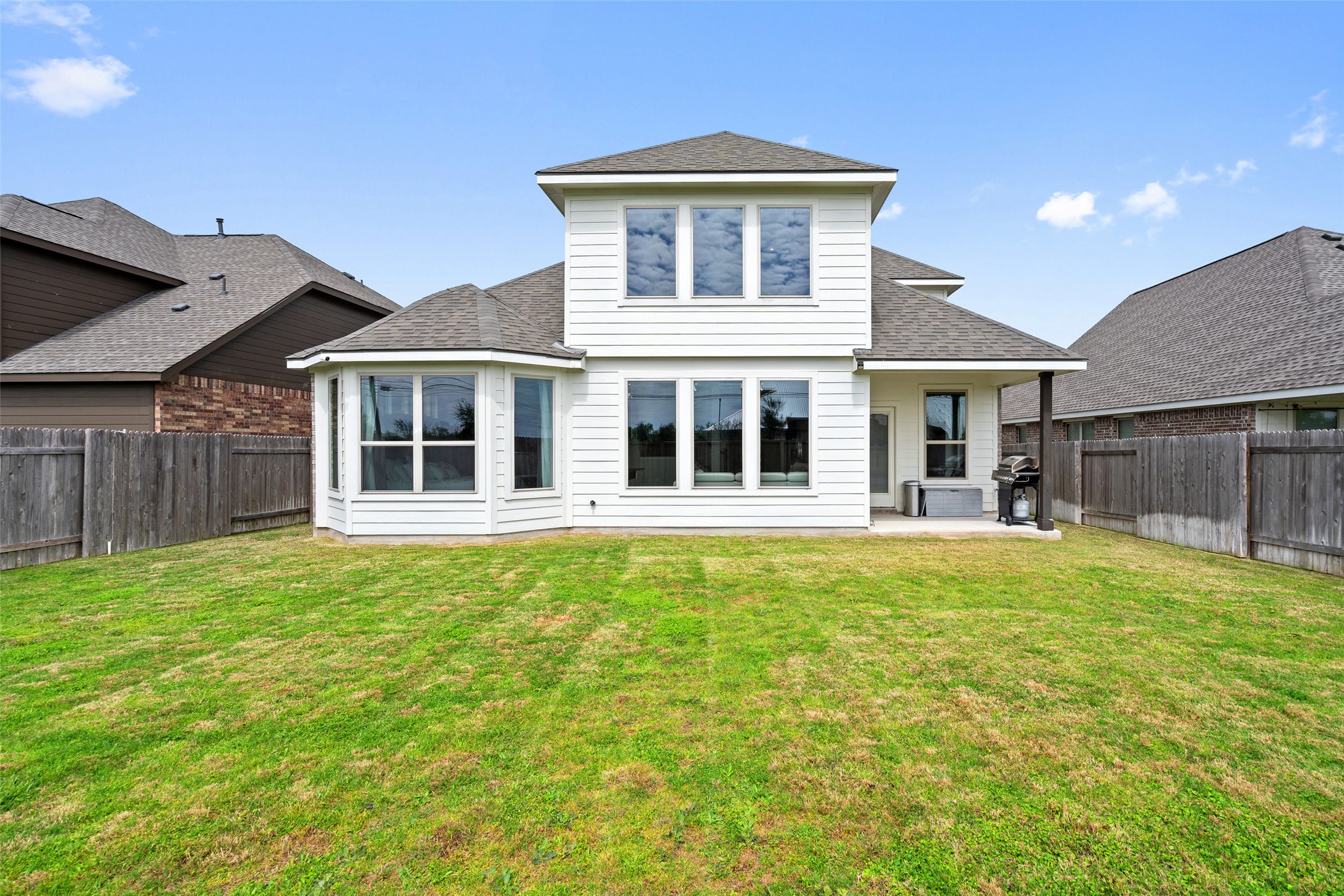 4101 Gildas Path Pflugerville, TX 78660 - Photo 15 of 16 Back of house with a shingled roof, a patio area, and a fenced backyard