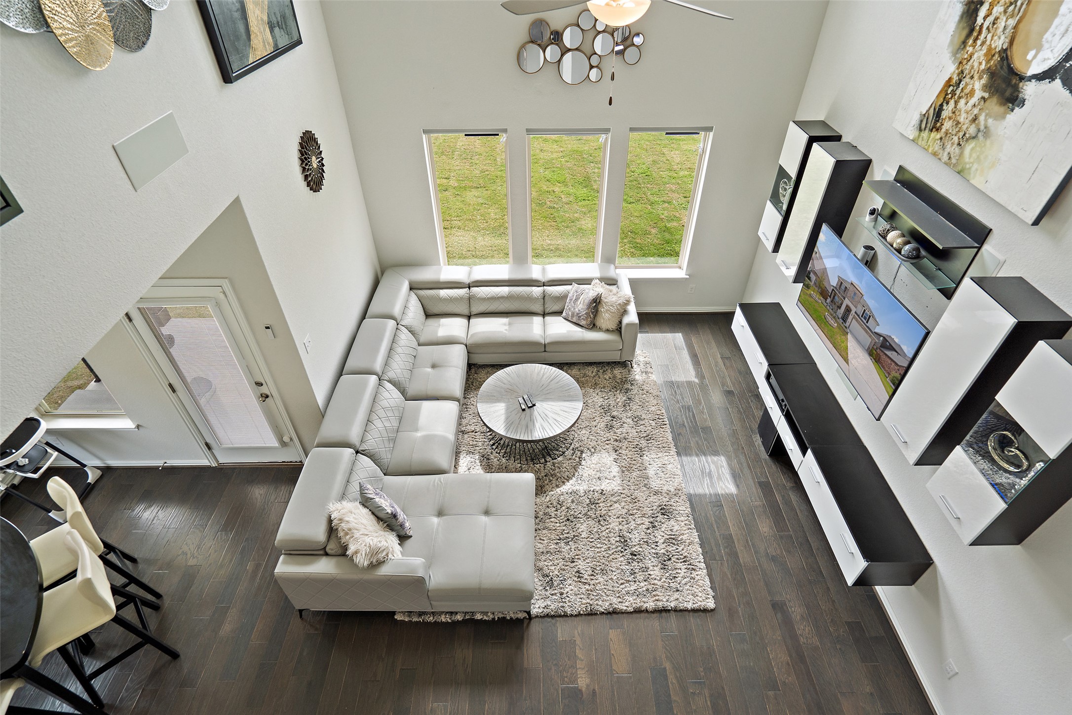 4101 Gildas Path Pflugerville, TX 78660 - Photo 7 of 16 Living room with dark wood-style flooring, a ceiling fan, and a high ceiling