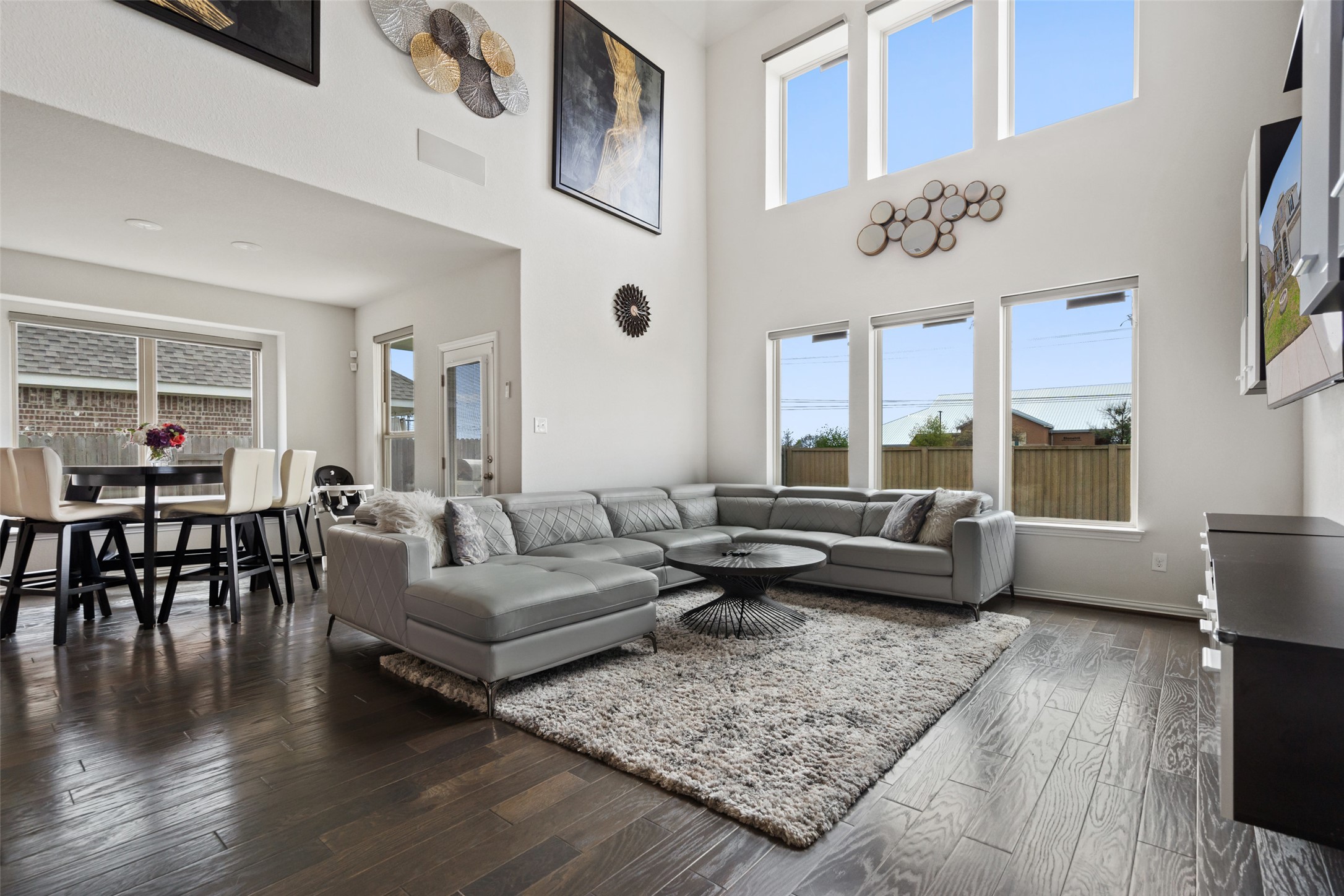 4101 Gildas Path Pflugerville, TX 78660 - Photo 8 of 16 Living area with dark wood finished floors, plenty of natural light, and a high ceiling