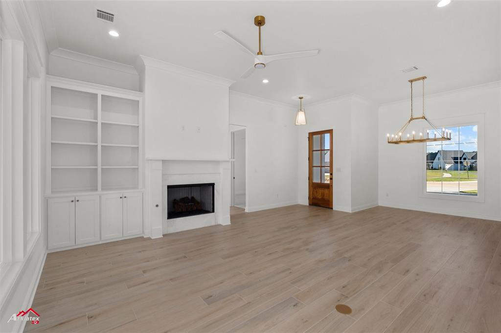 35 Turtle Creek Drive Benton, LA 71006 - Photo 10 of 32 an empty room with a fireplace and cabinet