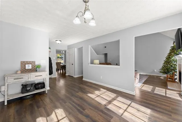 a view of a livingroom with wooden floor and a fireplace