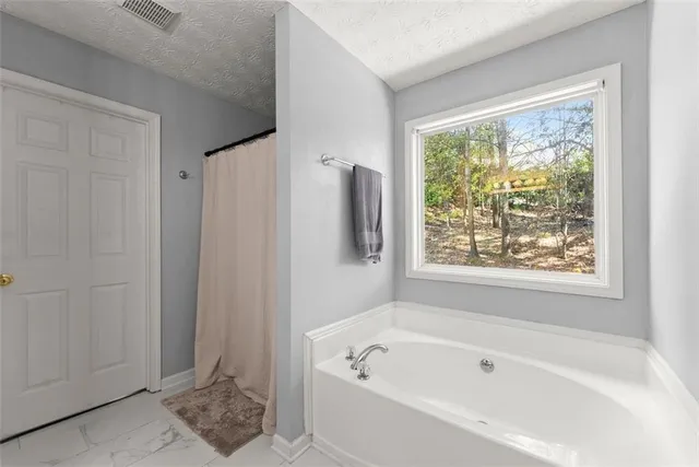 a white bath tub sitting next to a window