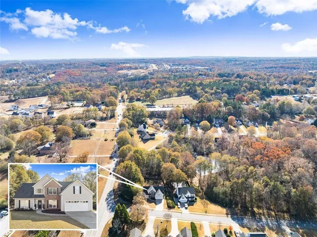 an aerial view of residential houses with city view